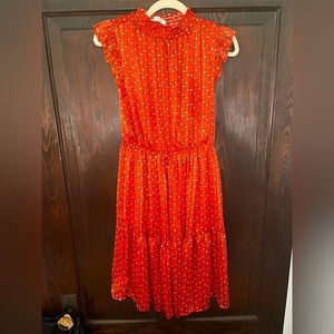 A orange mid length dress with floral details
